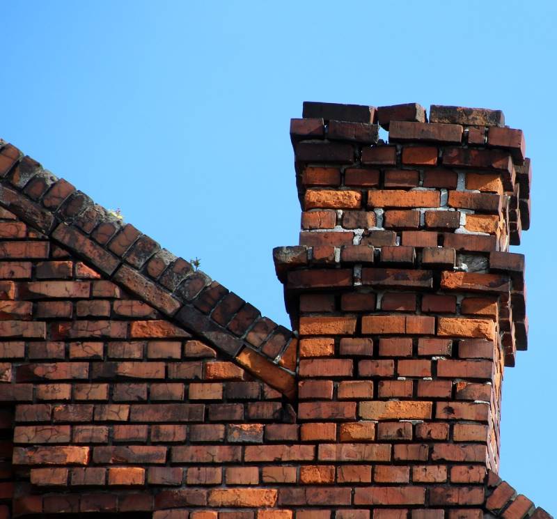 Signs Your Grand Prairie Home Needs a Chimney Inspection Damaged chimney on an Grand Prairie home showing cracks and missing mortar